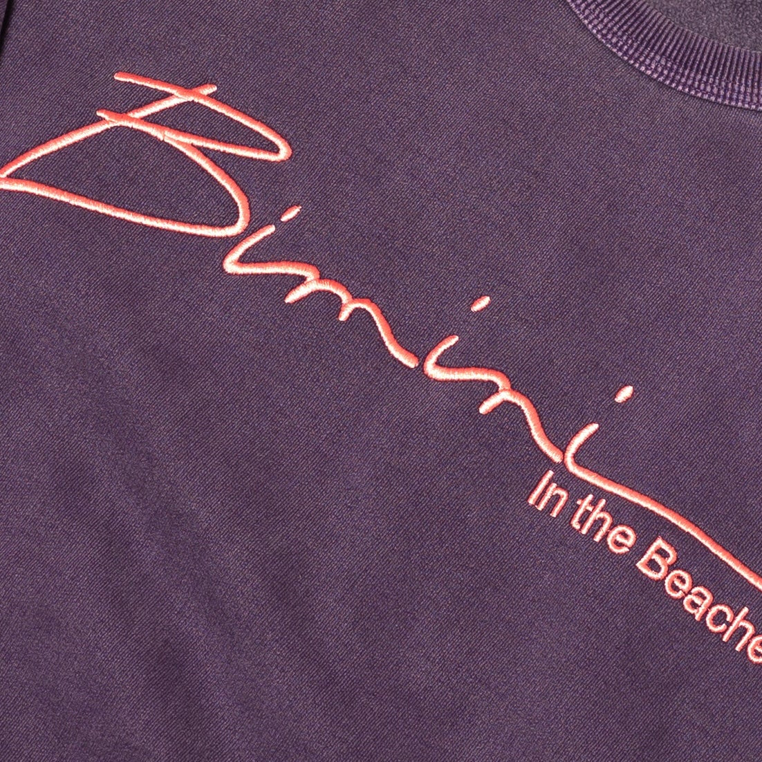 Close-up of a purple sweatshirt with pink embroidered "Bimini In the Beaches"