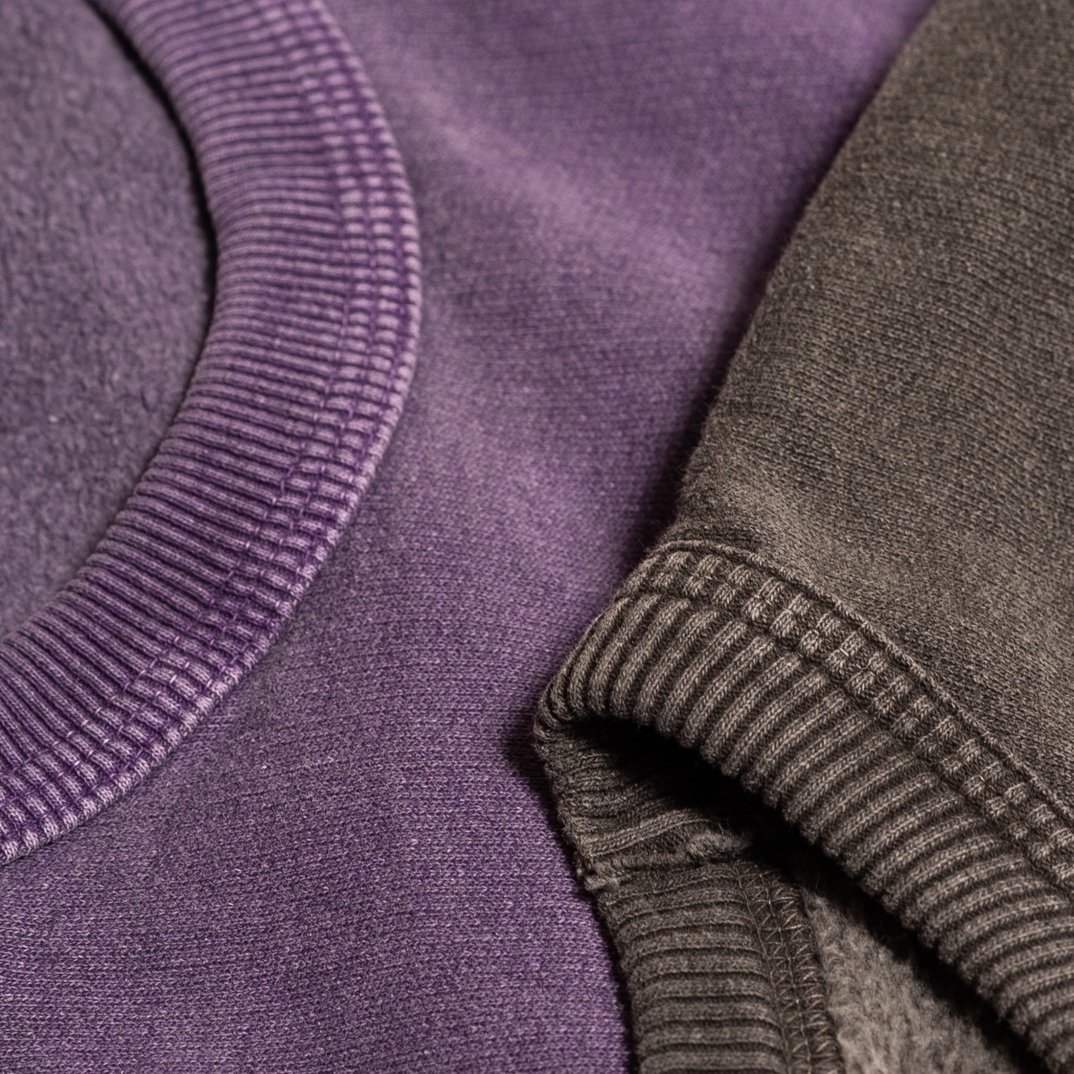 Close-up of purple and black fabric texture with a focus on the weave and colour.